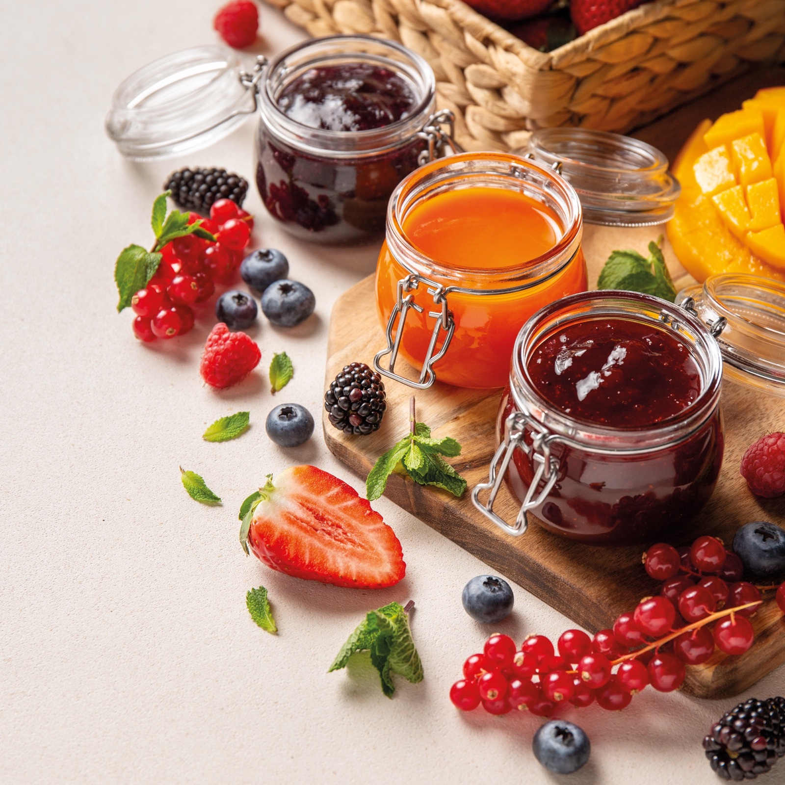 Artisan fruit pastes surrounded by fresh fruit